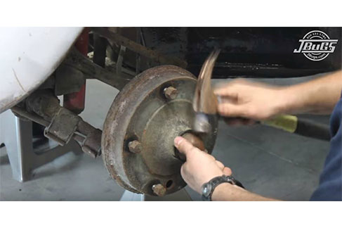 Remove grease cap to access the spindle nuts
